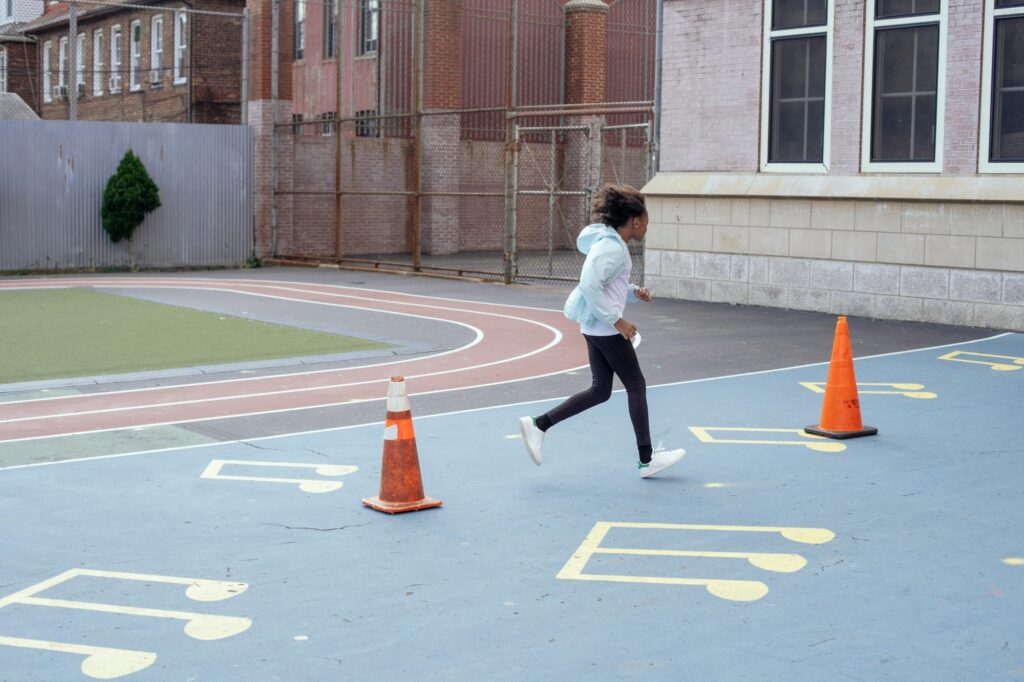 A young female student running at her school's playground