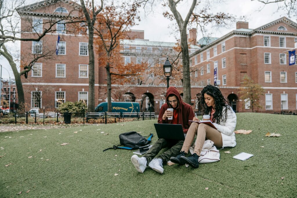 Two college students studying at their school's greenspace