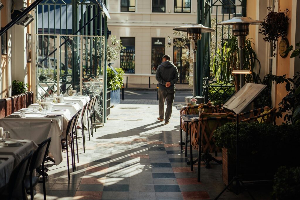 A restaurant with outdoor tables and chairs